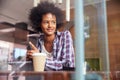 Businesswoman On Phone Using Digital Tablet In Coffee Shop Royalty Free Stock Photo