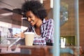 Businesswoman On Phone Using Digital Tablet In Coffee Shop Royalty Free Stock Photo