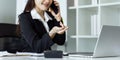Businesswoman on the phone and using laptop at office. Businesswoman professional talking on mobile phone Royalty Free Stock Photo