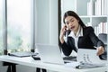 Businesswoman on the phone and using laptop at office. Businesswoman professional talking on mobile phone Royalty Free Stock Photo