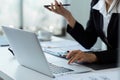 Businesswoman on the phone and using laptop at office. Businesswoman professional talking on mobile phone Royalty Free Stock Photo