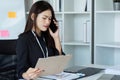 Businesswoman on the phone and using laptop at office. Businesswoman professional talking on mobile phone Royalty Free Stock Photo