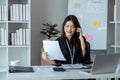 Businesswoman on the phone and using laptop at office. Businesswoman professional talking on mobile phone Royalty Free Stock Photo