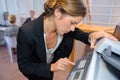 Businesswoman photocopying documents in office