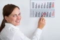 Businesswoman Placing Red Mark On Calendar Date