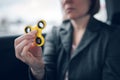 Businesswoman playing with fidget spinner in car