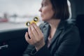 Businesswoman playing with fidget spinner in car