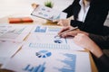 Businesswoman pointing pen on business document at meeting room. Discussion and analysis data charts and graphs showing the Royalty Free Stock Photo