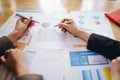 Businesswoman pointing pen on business document at meeting room. Discussion and analysis data charts and graphs showing the Royalty Free Stock Photo