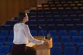 Businesswoman practicing for speech in the empty auditorium