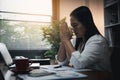 Businesswoman Praying with Eyes Closed. Businesswoman with her hands folded waiting for good news sitting at workplace at the Royalty Free Stock Photo