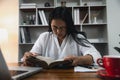 Businesswoman Praying with Eyes Closed. Businesswoman with her hands folded waiting for good news sitting at workplace at the Royalty Free Stock Photo