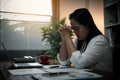 Businesswoman Praying with Eyes Closed. Businesswoman with her hands folded waiting for good news sitting at workplace at the Royalty Free Stock Photo