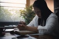 Businesswoman Praying with Eyes Closed. Businesswoman with her hands folded waiting for good news sitting at workplace at the Royalty Free Stock Photo