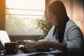 Businesswoman Praying with Eyes Closed. Businesswoman with her hands folded waiting for good news sitting at workplace at the Royalty Free Stock Photo