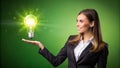 Businesswoman Presenting a Glowing Lightbulb - Innovation Design Royalty Free Stock Photo