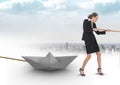 Businesswoman pulling paper boat with rope in city Royalty Free Stock Photo