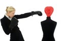 Businesswoman punching a dummy