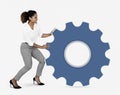 Businesswoman pushing a blue cogwheel Royalty Free Stock Photo