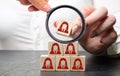 Businesswoman puts wooden blocks with the image of female employees. The concept of management in a team. Human resources. Women`