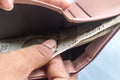 Businesswoman putting or taking out or paying Indian rupee banknotes from leather wallet. Isolated white background. Earning