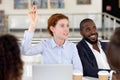 Businesswoman raising hand ask question at diverse group corporate training