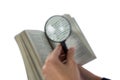 Businesswoman reading a dictionary through magnifying glass Royalty Free Stock Photo