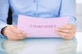 Businesswoman reading layoff notice Royalty Free Stock Photo