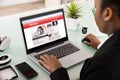 Businesswoman Reading News On Laptop Royalty Free Stock Photo