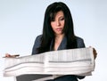 Businesswoman reading newspaper