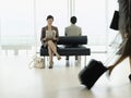 Businesswoman Reading Newspaper At Airport Lobby Royalty Free Stock Photo