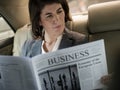 Businesswoman Reading Newspaper Car Inside Royalty Free Stock Photo
