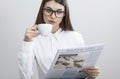 Businesswoman reading newspaper on gray background Royalty Free Stock Photo