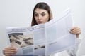 Businesswoman reading newspaper on gray background Royalty Free Stock Photo