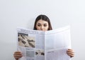 Businesswoman reading newspaper on gray background Royalty Free Stock Photo