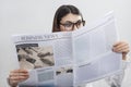 Businesswoman reading newspaper on gray background Royalty Free Stock Photo