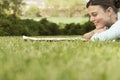 Businesswoman Reading Newspaper While Lying On Grass Royalty Free Stock Photo