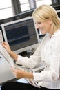 Businesswoman Reading Newspaper At Work Desk Royalty Free Stock Photo