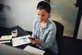 Businesswoman reading a text on her cellphone in an office Royalty Free Stock Photo