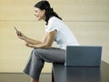 Businesswoman Reading Text Message In Lobby