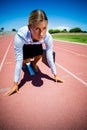 Businesswoman ready to run on running track Royalty Free Stock Photo