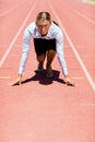 Businesswoman ready to run on running track Royalty Free Stock Photo