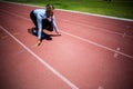 Businesswoman ready to run on running track Royalty Free Stock Photo