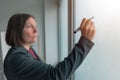 Businesswoman ready to write on office whiteboard Royalty Free Stock Photo