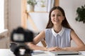Young businesswoman recording vlog talking to camera seated indoors Royalty Free Stock Photo