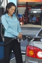 Businesswoman Refueling Car