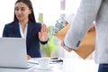 Businesswoman rejecting bribe at table Royalty Free Stock Photo