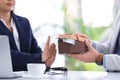 Businesswoman rejecting bribe at table indoors Royalty Free Stock Photo