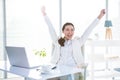 Businesswoman rejoicing with arms outstretched