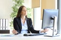 Businesswoman relaxing doing yoga at office